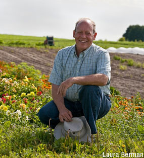 David Cohlmeyer smiling with his farm in the background